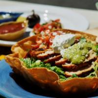 Taco Salad · An organic flour tortilla basket filled with choice of meat. Choice of beans. Romaine, chees...