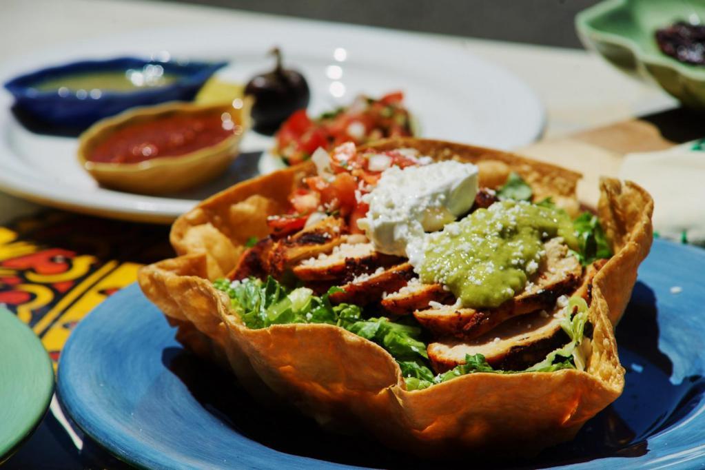 Taco Salad · An organic flour tortilla basket filled with choice of meat. Choice of beans. Romaine, cheese, sour cream, guacamole, tomato, cilantro and onion.