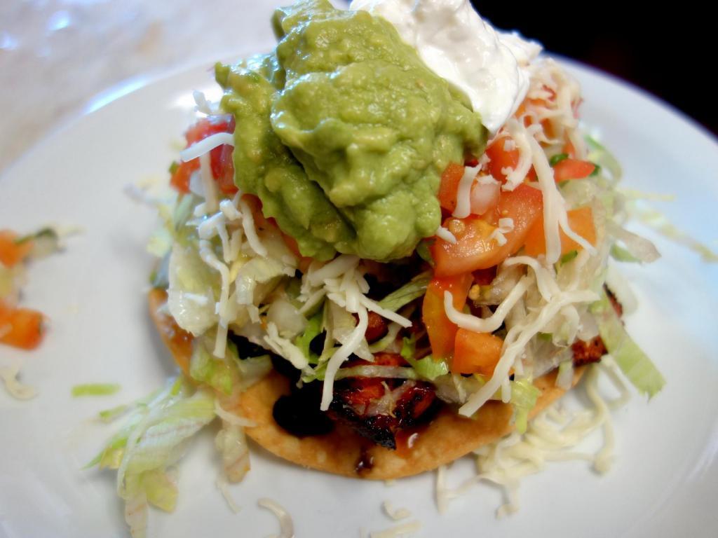 Tostada Salad · Crispy corn tortilla topped with choice of meat. Romaine, refried beans, sour cream, guacamole, tomato, cilantro and onion.