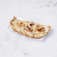 24. Naan · White flour dough with milk and butter baked in clay oven.