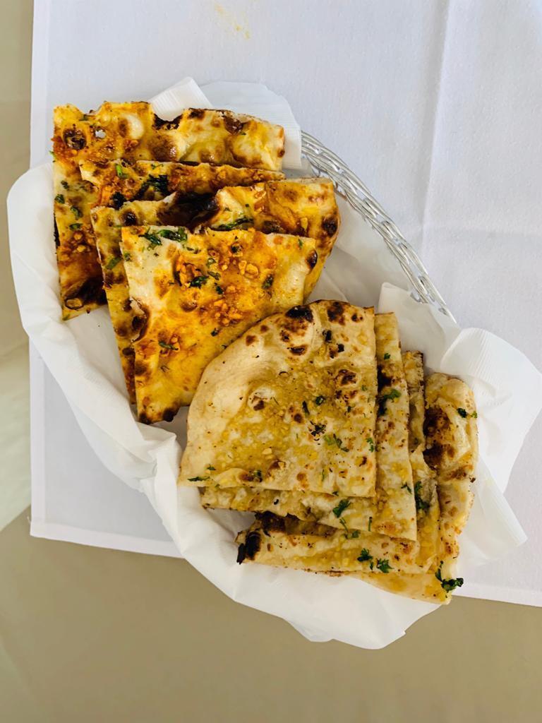 Garlic Naan · Fresh dough stuffed with garlic and spices, baked in the clay oven.