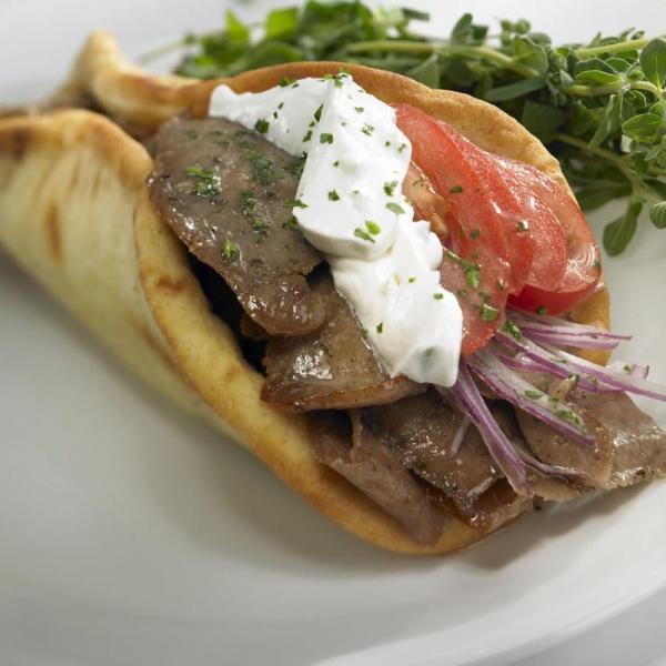 Gyro · Roasted beef and lamb on gyro bread, with tzatziki sauce topped with lettuce, tomato and onion.