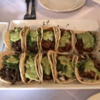 TACO TRAY · 10 tacos with choice of  3 meats, topped with cilantro, onions, guacamole sauce, pearl onion...