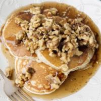 Pancakes with peanut butter and walnuts  ·  Topped with creamy peanut butter and garnished with walnuts.  
