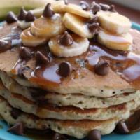 Banana chocolate chip Pancakes  · Pancakes with chocolate chips baked inside and topped with fresh bananas 