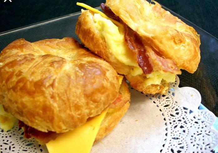 Croissant Bacon Egg and Cheese · Fried egg with bacon and melted cheese on a lightly toasted croissant.