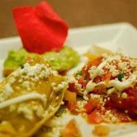 Tamalitos · Two homemade corn tamales stuffed with chicken topped with our Frida sauce, Zapata sauce, qu...