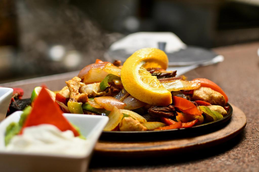 New Rebozo Vegetable & Shrimp Fajitas · Sautéed shrimp and assortment of vegetables cooked with sizzling bell peppers, and onions. With side of sour cream and beans.