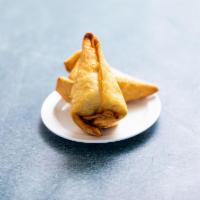 Vegetarian Samosas · 2 pieces. Crisp turnovers stuffed with spiced potatoes and sweet peas.