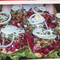 Enchiladas Chapinas · Guatemalan enchiladas: tostada with beet curtido, ground beef, red sauce, topped with egg, o...