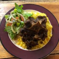 Oxtails over Rice · Special Braised oxtails over Spanish rice.