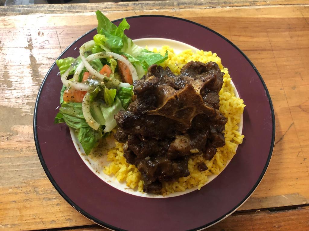 Oxtails over Rice · Special Braised oxtails over Spanish rice.