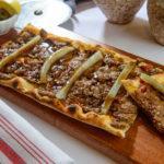 Soujouk Flatbread · Ground beef soujouk cheese, tomato and pickles.