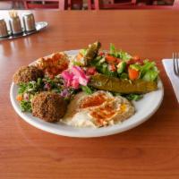 Vegetarian Combo · Two falafel, 2 grape leaves, hummus, babaghanoush, tabouleh, house salad, and pita bread.