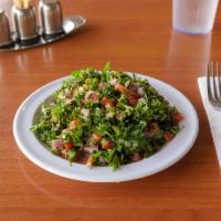 Tabouleh Salad · Finely chopped parsley, cracked wheat, tomato, lemon juice, mint, and olive oil.