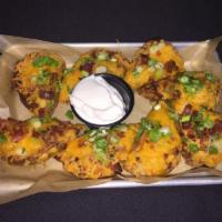 Potato Skins · Topped with cheddar, bacon, green onions and sour cream.