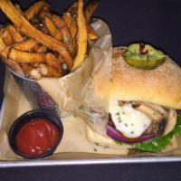 Mushroom Swiss Burger · Angus burger topped with sauteed mushrooms and Swiss cheese. Served with fries. Burger prepa...
