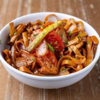 Wok Fettuccini Saltado con Carne O Pollo · Peruvian style fettuccini with stir-fry beef or chicken, sauteed with red onions, tomato and...