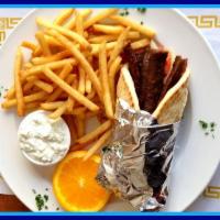 Gyro in Greek Pita Sandwich · Seasoned and braised beef and lamb mixture wrapped in Greek pita bread with tomatoes and oni...