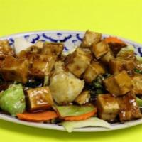 68. Garlic Tofu · Fried tofu with fresh garlic and peppers sauce on top of steamed vegetables.