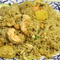 56. Pineapple Fried Rice · Fried rice with prawns, chicken and egg mixed with pineapple, carrots, peas, tomatoes, raisi...