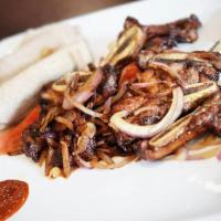 Goden Tibs · Sizzling prime short ribs marinated with Desta sauce, onion, tomato, fresh garlic and jalape...