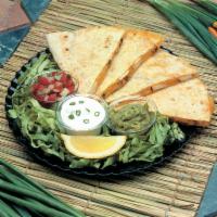 Chicken Quesadilla · Melted Jack and cheddar cheeses and juicy fire grilled chicken breast in a large flour torti...