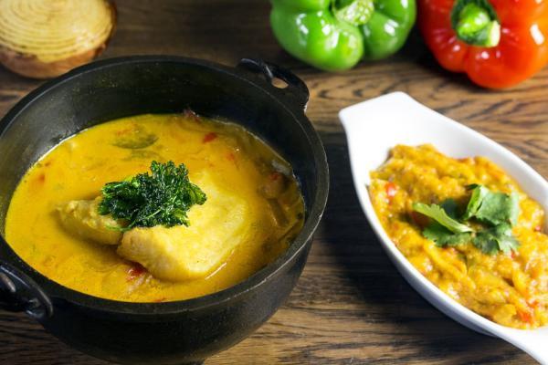 Moqueca de Peixe com Pirao · Fish stew made with palm oil, green herbs, onions, tomatoes and coconut milk served with pinao (a puree made of made of pan dripping and cassava flour). Includes house salad and rice.