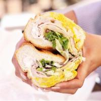 Turkey Sandwich · Served with mustard, mayo, pickles, pepperoncini, lettuce, and tomato and red onion.