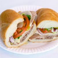 Italian Combo Deluxe Sandwich · Imported salami, mortadella, capacolla, provolone cheese, lettuce, tomatoes, pepperoncinis, ...