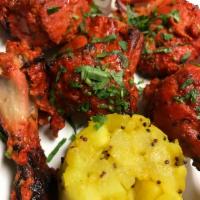 Tandoori Chicken · Chicken marinated in fresh spices and lemon, then barbecued over flaming charcoal in the tan...