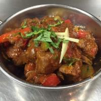 Lamb Karahi · Chunks of lamb and northern spices cooked with tomatoes, onions and green peppers. 