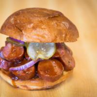 Sausage Sandwich · Served with pickles, red onions and sauce.