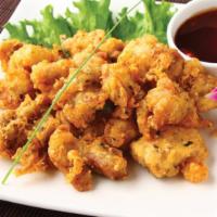 Sesame Chicken · Marinated chicken lightly battered and deep fried with sesame seeds.