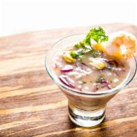Leche de Tigre · Cocktail of fresh squeezed lime blended with diced seafood, onions and sprinkled cilantro se...