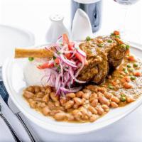 Seco de Cordero con Frijoles · Lamb hind shank braised in cilantro sauce. Served with garlic white rice, Peruvian beans, an...