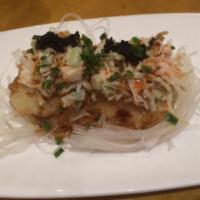 Scallop tempura with snow crab · Two pieces of scallop tempura with snow crab salad on top.