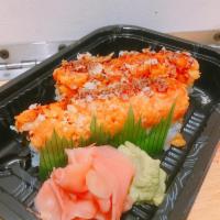 Spicy Crispy Salmon Maki · Cucumber, cream cheese, spicy mayo, tempura flakes topped with salmon, flying fish roe, temp...