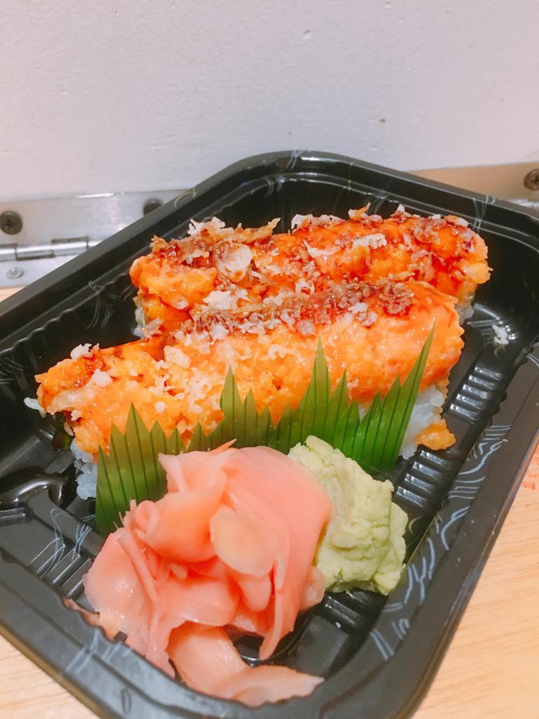 Spicy Crispy Salmon Maki · Cucumber, cream cheese, spicy mayo, tempura flakes topped with salmon, flying fish roe, tempura flakes and eel sauce.