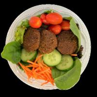 Falafel Tasa (Bowl) · Arugula and mixed greens. Topped with 3 pieces Falafel cherry tomatoes, shredded carrots, cu...