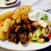 Pork Souvlaki Platter · Served with Greek salad, pita, tzatziki and your choice of side.
