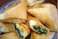 Spanakopita · Spinach mix with feta cheese and herbs. Wrapped with phyllo dough.