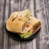 The Gyro · Combination of beef-lamb seasoned meat inside pita with lettuce, tomato, onion and served wi...