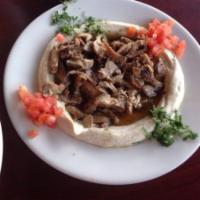Hummus With Meat · Hummus topped with sliced beef shawarma. 