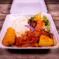 Lomo de Cerdo a La Criolla · Grilled pork sirloin served with yucca root, potatos, rice, salad and sweet plantains.