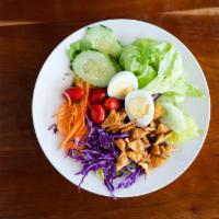Thai Salad · Iceberg lettuce, cabbage, cucumber, boiled egg, fried wonton, carrot, red cabbage, tomato, p...