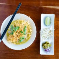 Khao Soi · Chicken, egg noodle in a Northern style curry soup topped with crispy egg noodles, served wi...