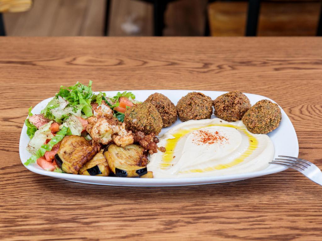 Falafel Platter · ground chickpeas, splendidly spiced, flavored with fresh herbs and fried until golden. Served with salad, hummus and a fluffy pita 