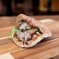 Falafel Deluxe Sandwich · Traditional falafel sandwich + fried eggplant served on toasted wrap or fluffy pita+ hummus ...