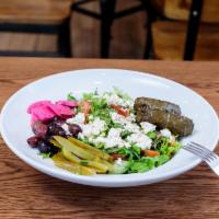 Greek Salad · Traditional fattoush salad topped with feta cheese, grape leaves, Kalamata olives, oregano, ...